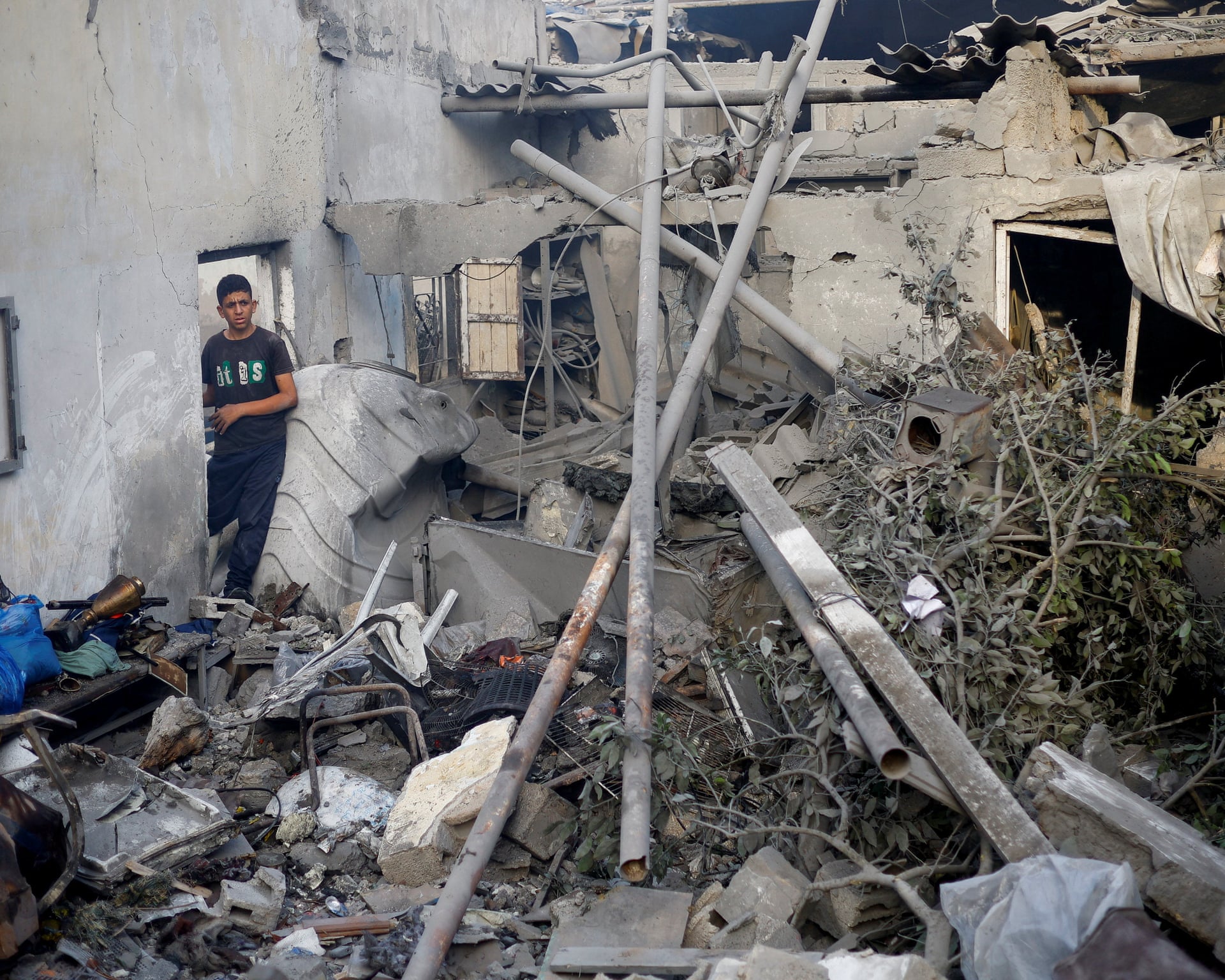 A Palestinian boy stands in the ruins of a destroyed house in Gaza.
